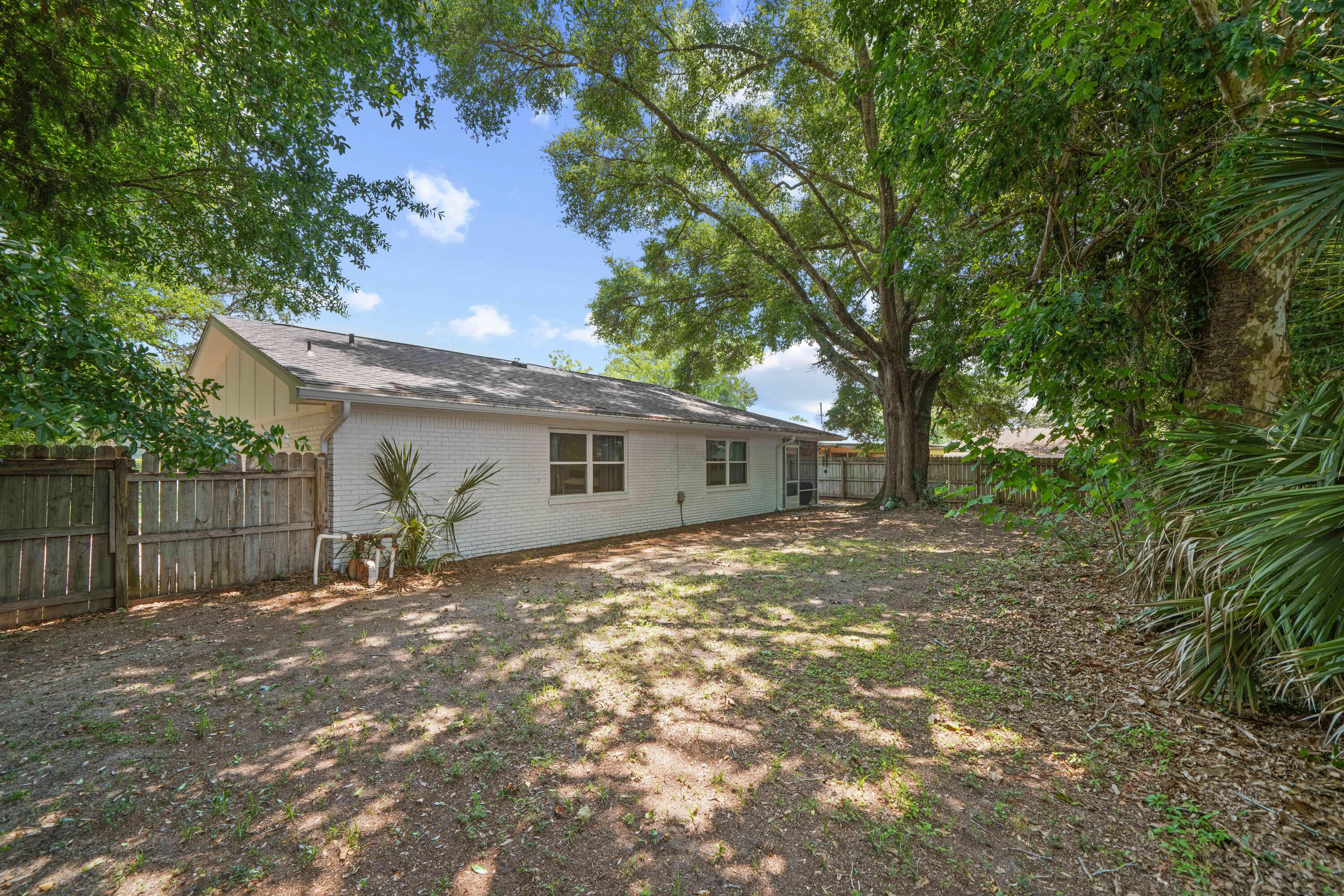 39 9th Street Shalimar, FL 32579 - Photo 34 of 37 a view of a yard in front of a house with large tree