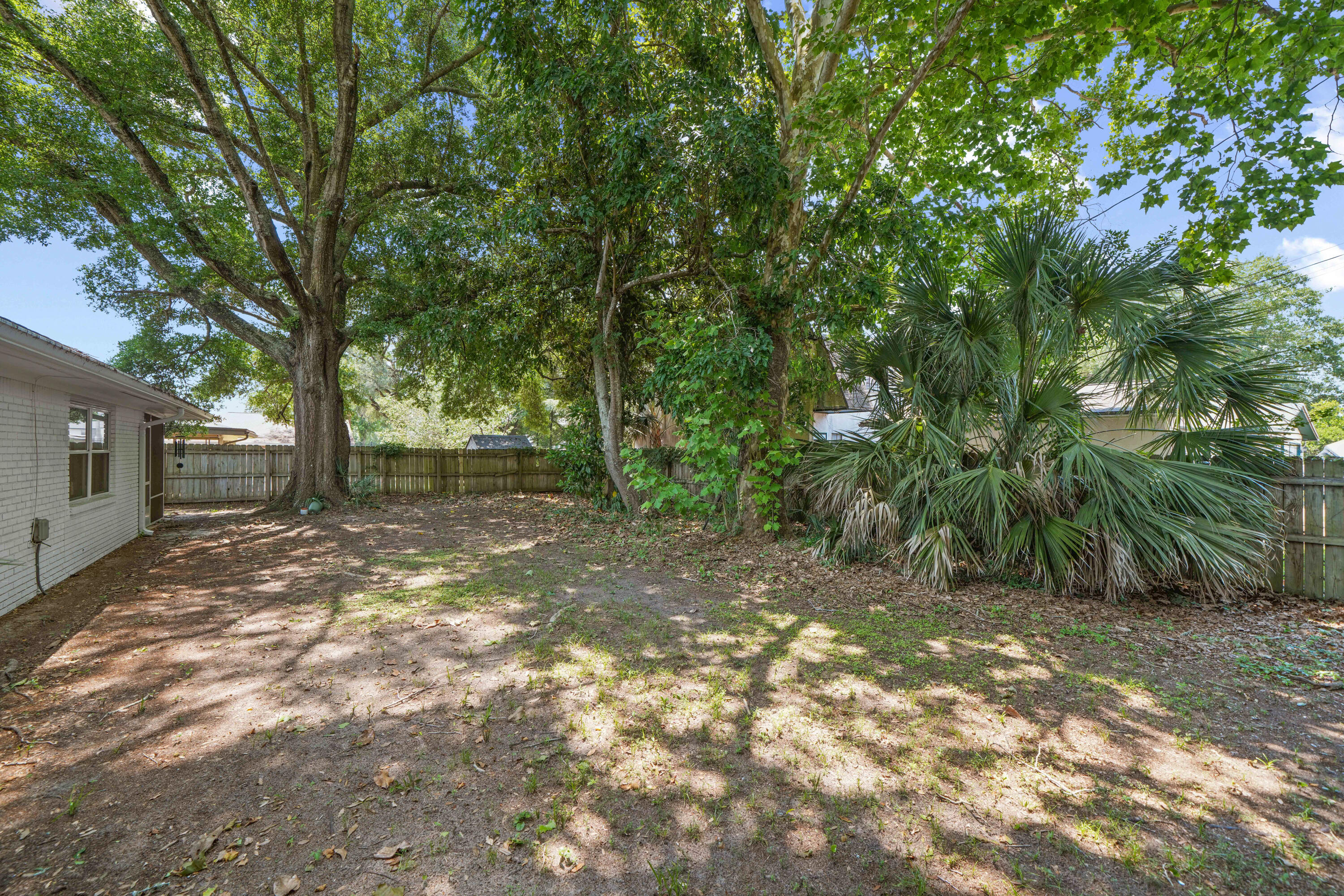39 9th Street Shalimar, FL 32579 - Photo 35 of 37 a view of a yard with a tree