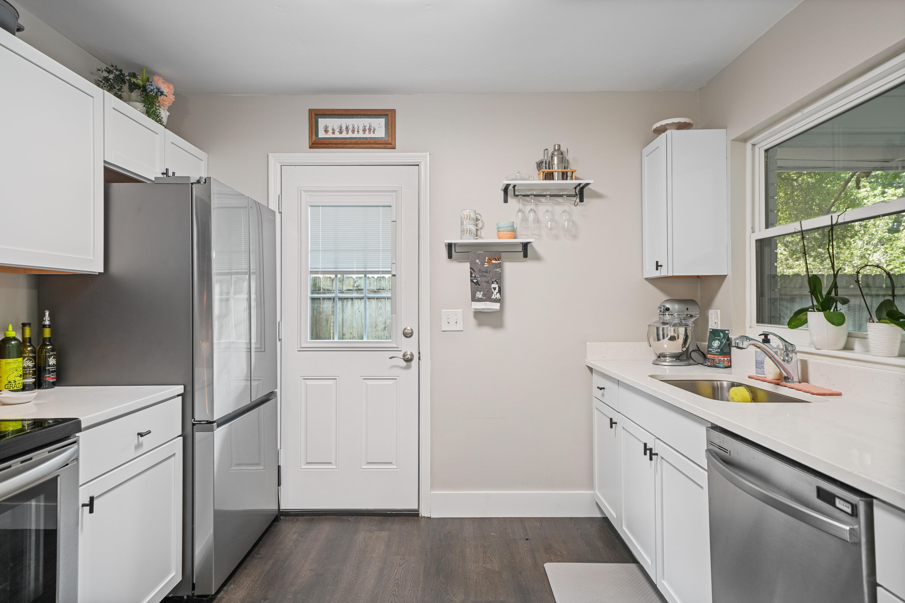 39 9th Street Shalimar, FL 32579 - Photo 4 of 37 a kitchen with a sink dishwasher a refrigerator a stove and a window with wooden floor