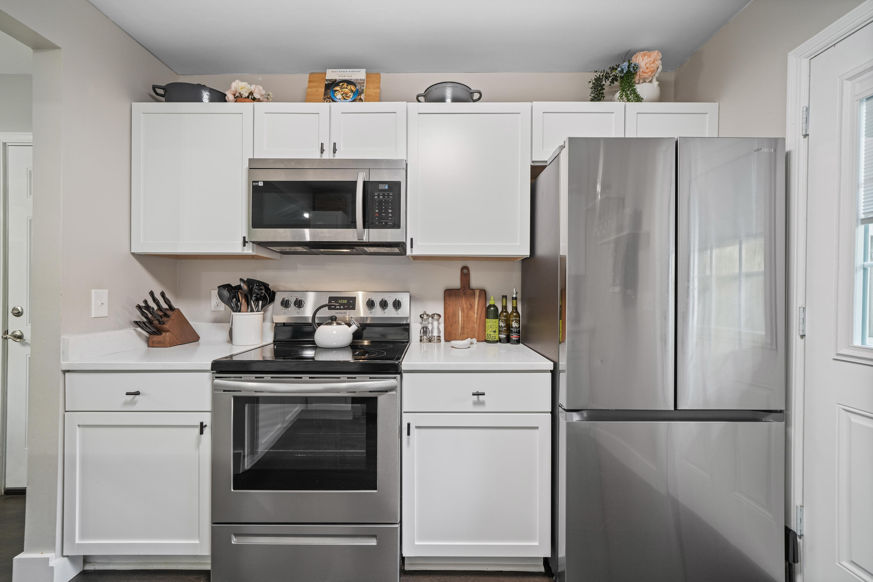 39 9th Street Shalimar, FL 32579 - Photo 6 of 37 a kitchen with stainless steel appliances white cabinets and white appliances