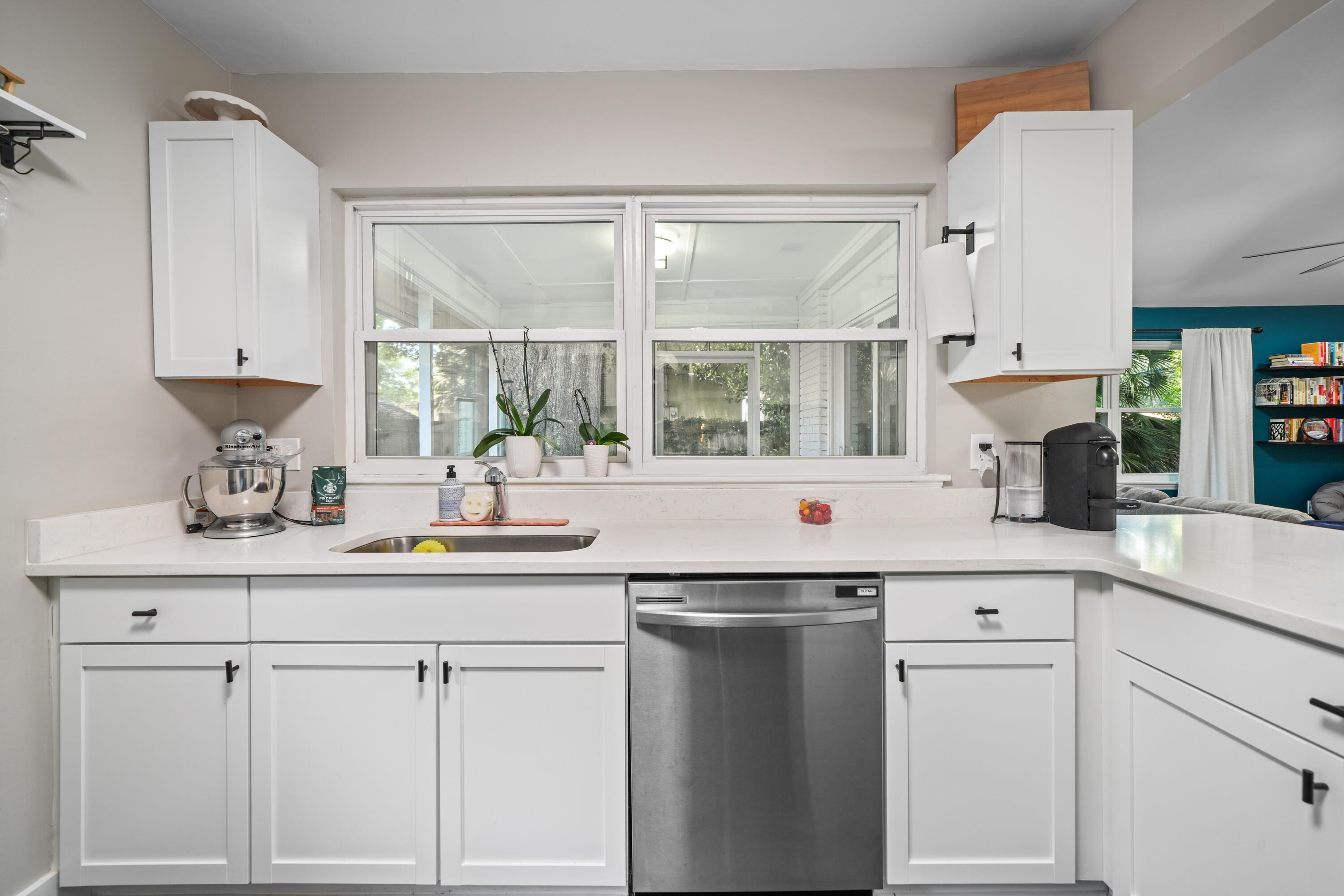 39 9th Street Shalimar, FL 32579 - Photo 7 of 37 a kitchen with white cabinets and sink
