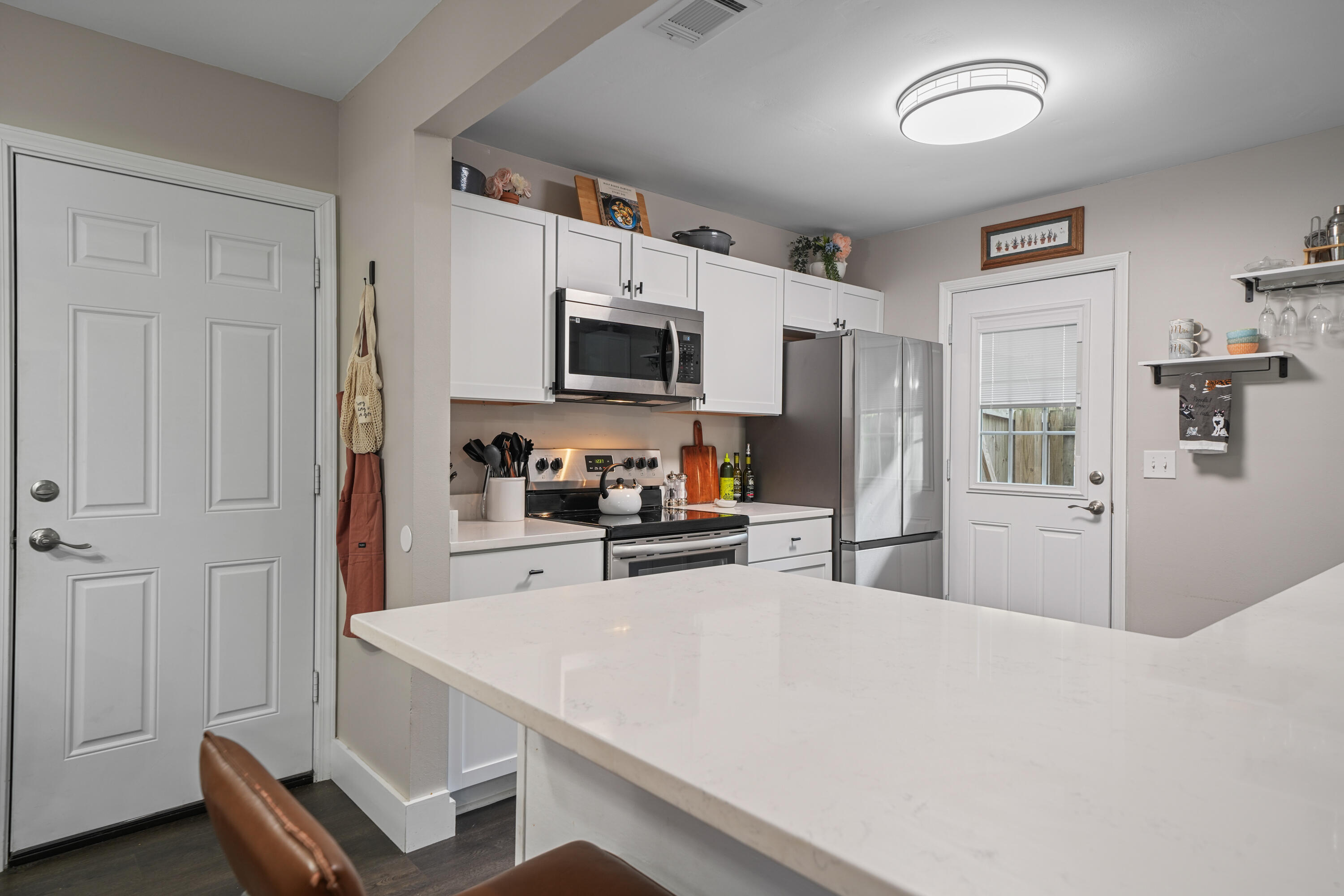39 9th Street Shalimar, FL 32579 - Photo 8 of 37 a kitchen with kitchen island a refrigerator stove microwave and sink