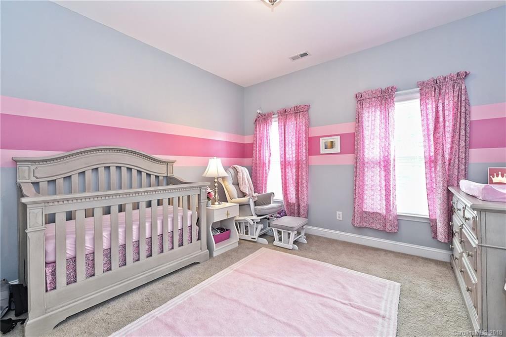 543 Quicksilver Trail Fort Mill, SC 29708 - Photo 22 of 36 a bedroom with furniture and a large window