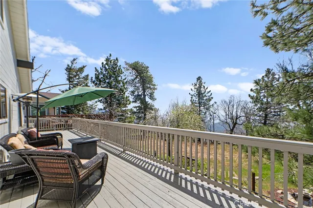 a view of balcony with wooden floor and outdoor seating