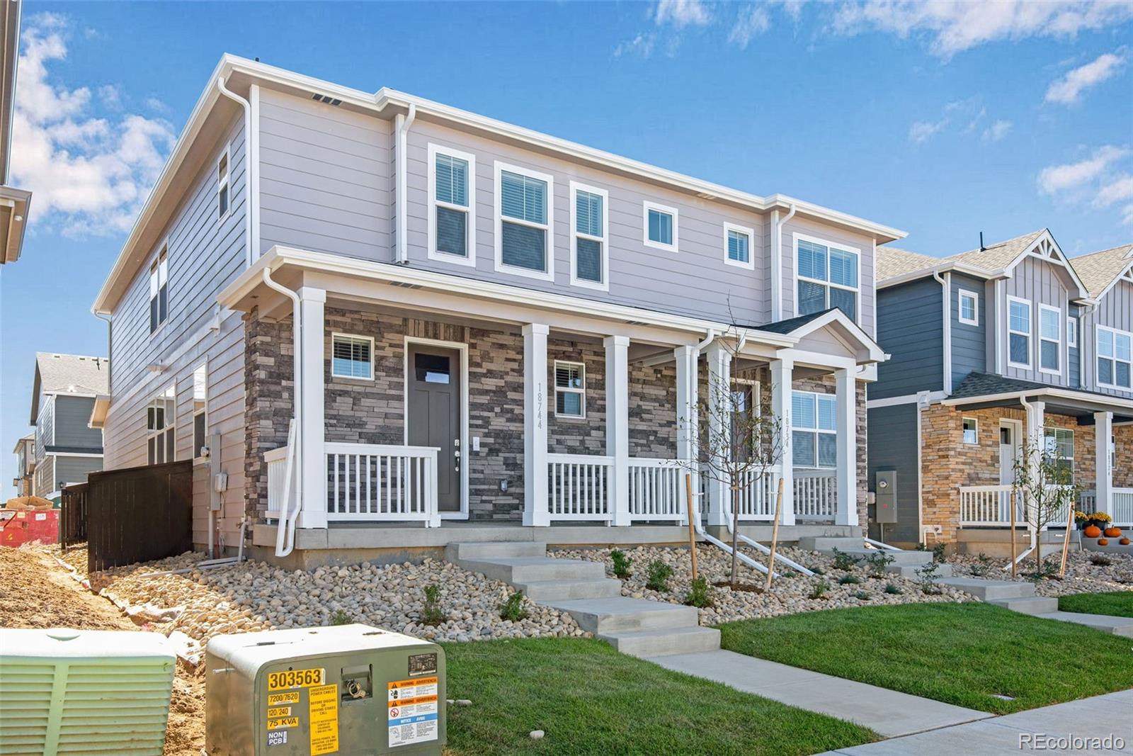 1341 South Chester Street, Unit B Denver, CO 80247 - Photo 2 of 14 a front view of a house with garden