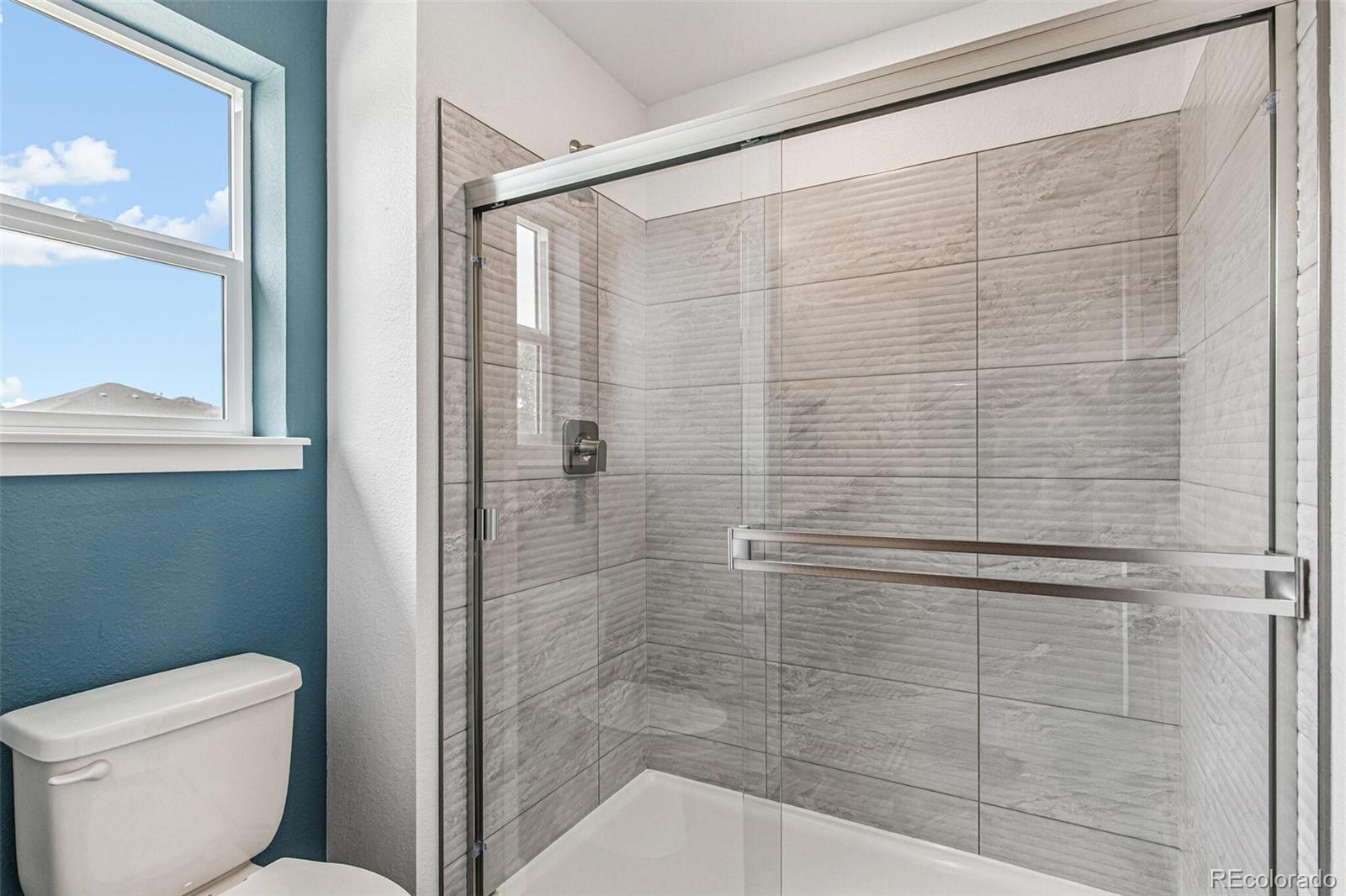 1341 South Chester Street, Unit B Denver, CO 80247 - Photo 9 of 14 a bathroom with a shower and toilet