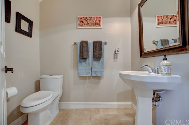 8546 Millpond Place Riverside, CA 92508 - Photo 18 of 60 a bathroom with a toilet sink and mirror