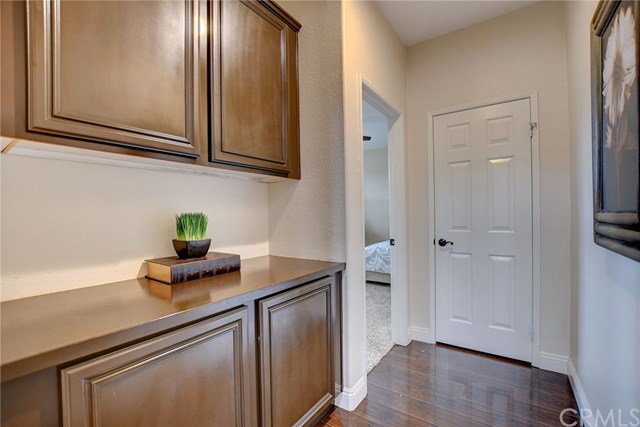 8546 Millpond Place Riverside, CA 92508 - Photo 19 of 60 a kitchen with stainless steel appliances granite countertop white cabinets and wooden floor