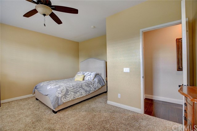8546 Millpond Place Riverside, CA 92508 - Photo 20 of 60 a bedroom with a bed and a chandelier