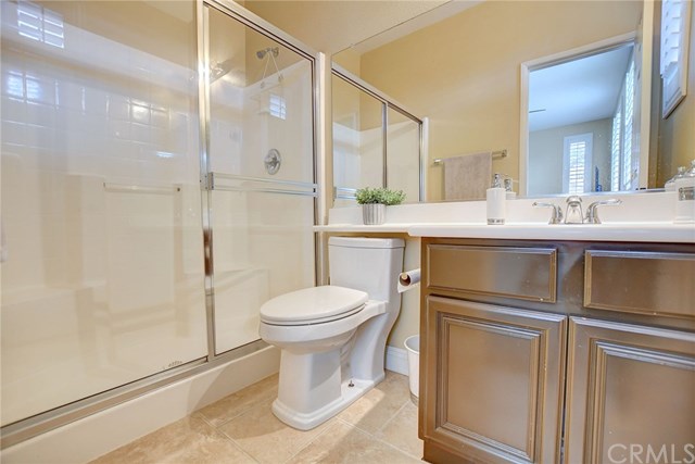 8546 Millpond Place Riverside, CA 92508 - Photo 21 of 60 a bathroom with a sink a toilet and shower
