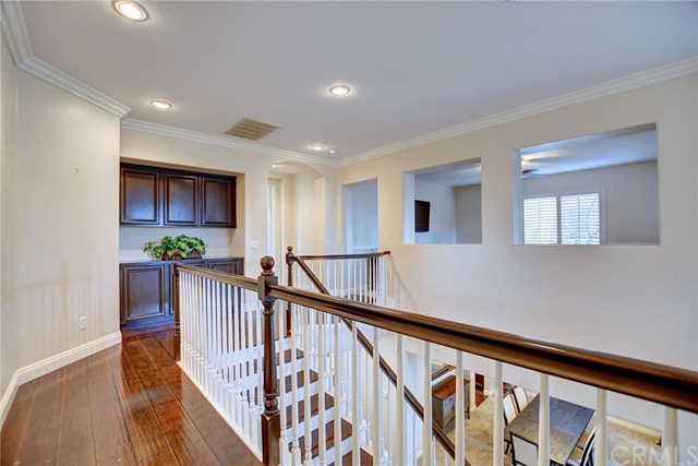 8546 Millpond Place Riverside, CA 92508 - Photo 23 of 60 a view of a hallway with wooden floor and stairs