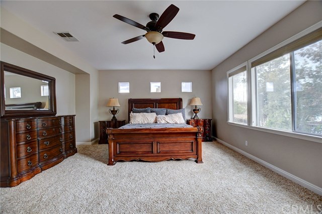 8546 Millpond Place Riverside, CA 92508 - Photo 26 of 60 a bedroom with a bed dresser and a flat tv screen