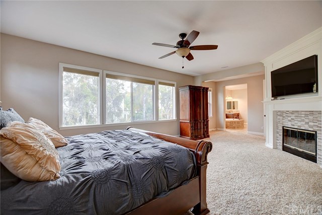 8546 Millpond Place Riverside, CA 92508 - Photo 27 of 60 a bed sitting in a room next to a window and a fireplace