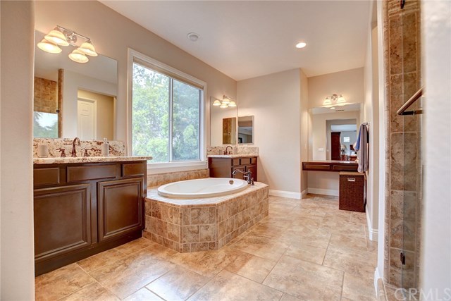 8546 Millpond Place Riverside, CA 92508 - Photo 28 of 60 a large bathroom with a double vanity sink and a mirror
