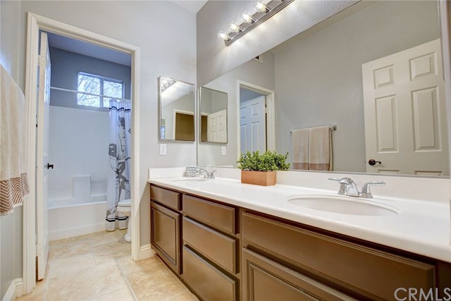8546 Millpond Place Riverside, CA 92508 - Photo 35 of 60 a bathroom with a sink double vanity and a bathtub
