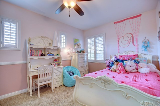 8546 Millpond Place Riverside, CA 92508 - Photo 36 of 60 a bedroom with a bed and a chandelier