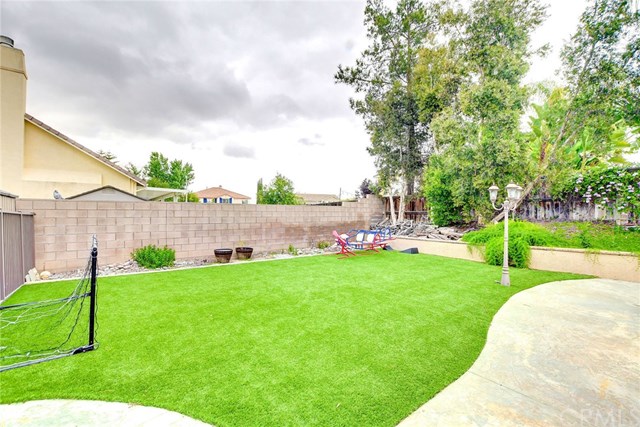 8546 Millpond Place Riverside, CA 92508 - Photo 46 of 60 a view of backyard with swimming pool and green space