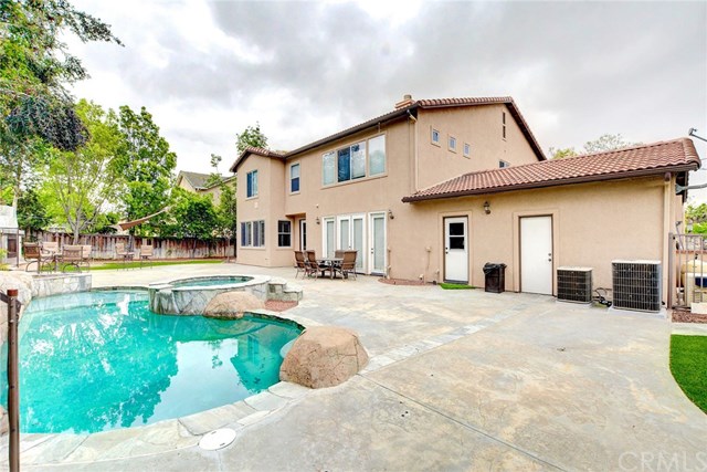 8546 Millpond Place Riverside, CA 92508 - Photo 49 of 60 a view of a house with swimming pool and a yard