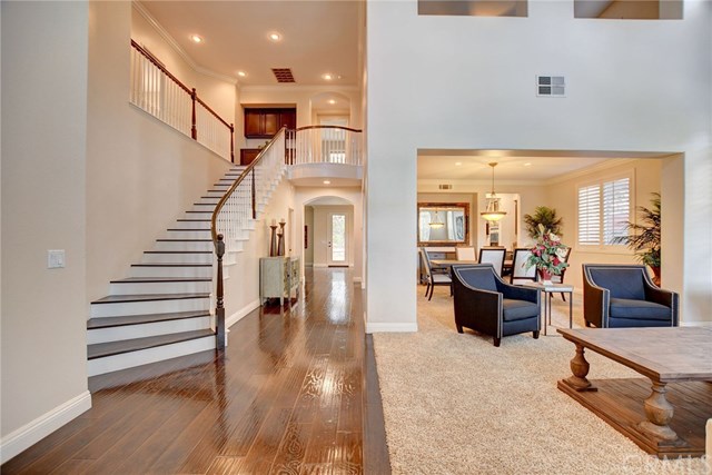 8546 Millpond Place Riverside, CA 92508 - Photo 6 of 60 a living room with furniture and a dining table with wooden floor