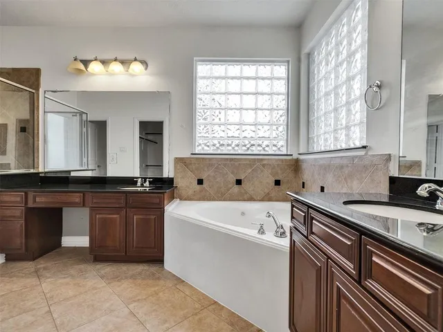 a view of a kitchen with a sink and dishwasher a refrigerator with white cabinets