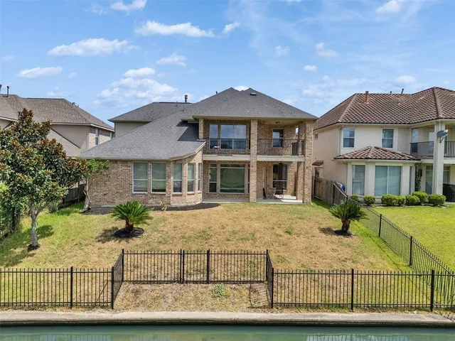 an aerial view of residential houses with outdoor space and lake view