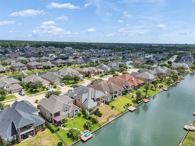an aerial view of a house with a lake view