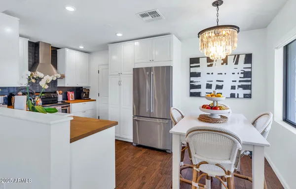 a kitchen with stainless steel appliances granite countertop a refrigerator and a sink