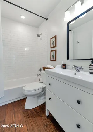 a bathroom with a double vanity sink mirror and toilet