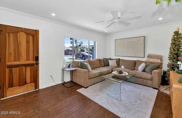 a living room with furniture and wooden floor