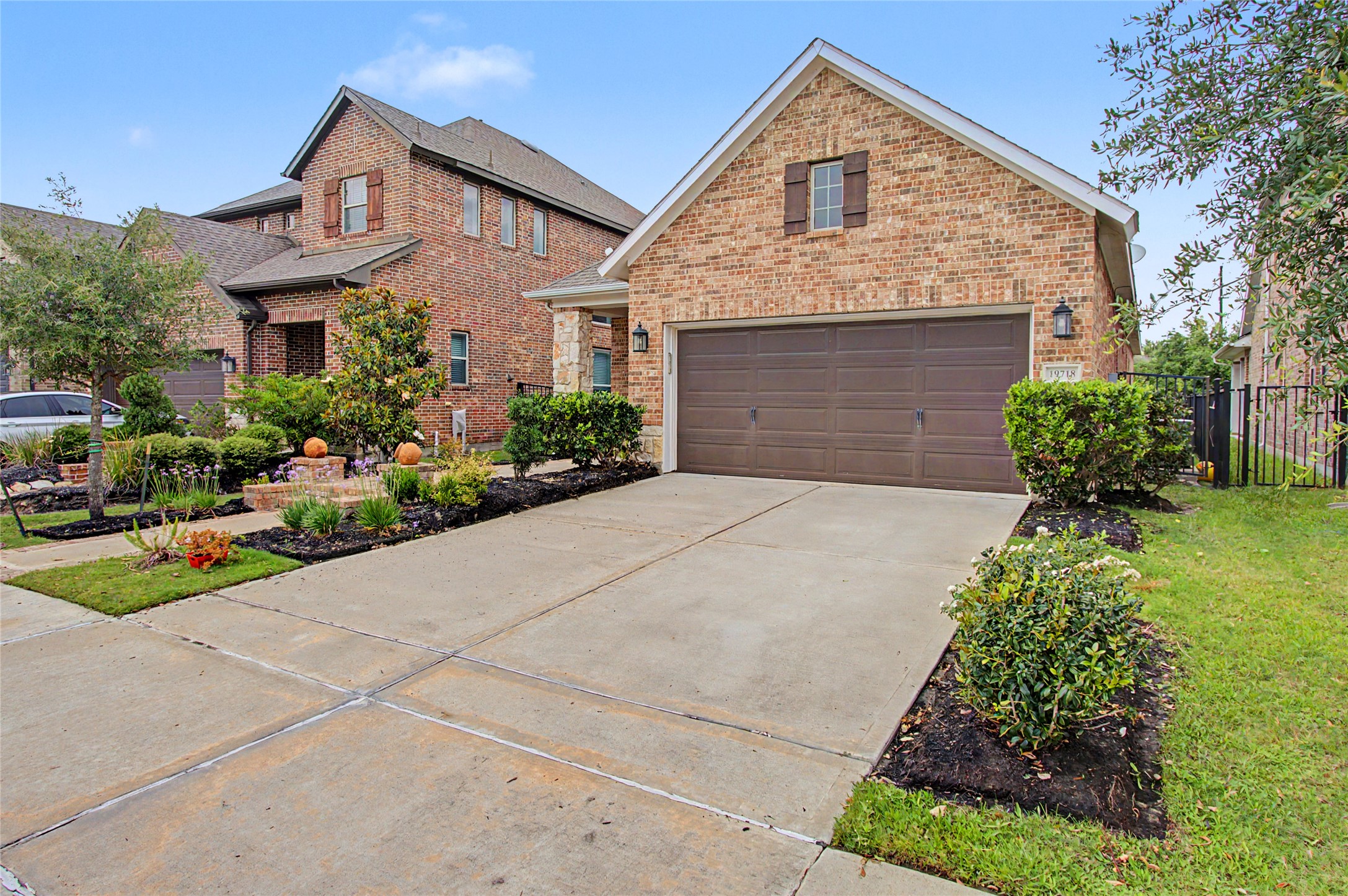 19718 Shinnery Ridge Court Cypress, TX 77433 - Photo 22 of 23 a front view of a house with a yard and potted plants