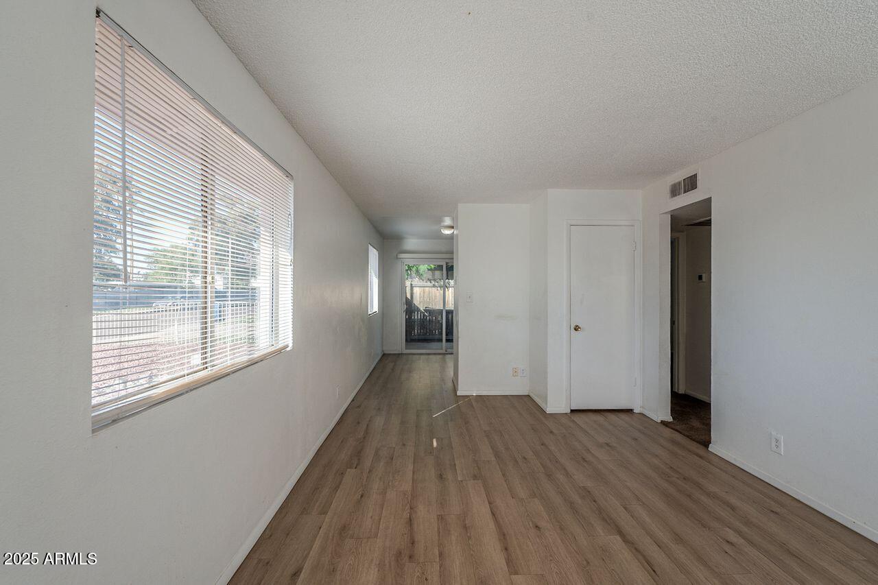2608 West Ocotillo Road Phoenix, AZ 85017 - Photo 13 of 56 a view of empty room with wooden floor