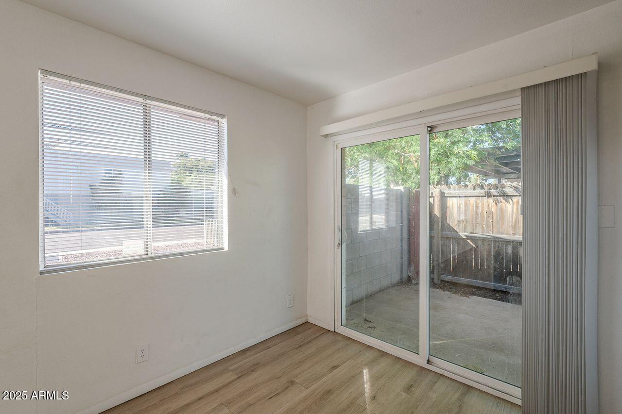 2608 West Ocotillo Road Phoenix, AZ 85017 - Photo 15 of 56 a view of an empty room with wooden floor and a window