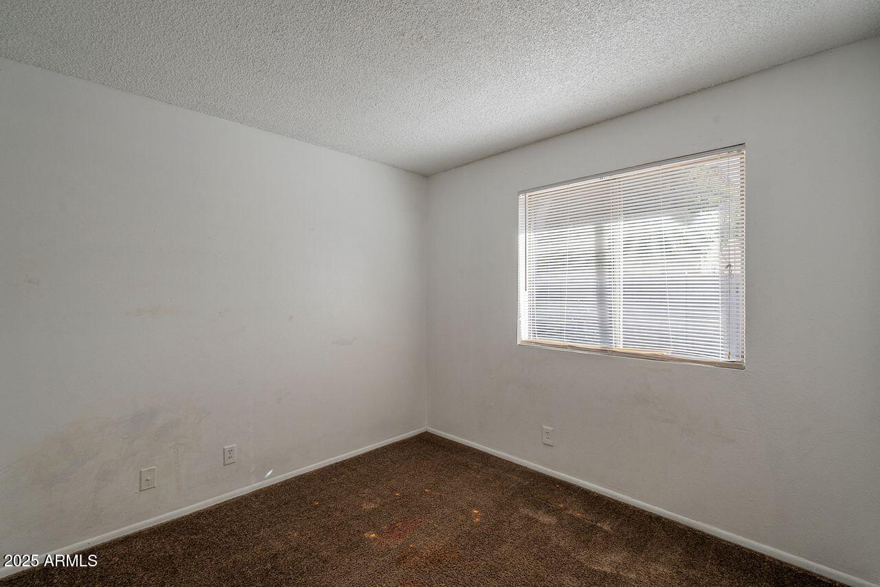 2608 West Ocotillo Road Phoenix, AZ 85017 - Photo 21 of 56 an empty room with a window