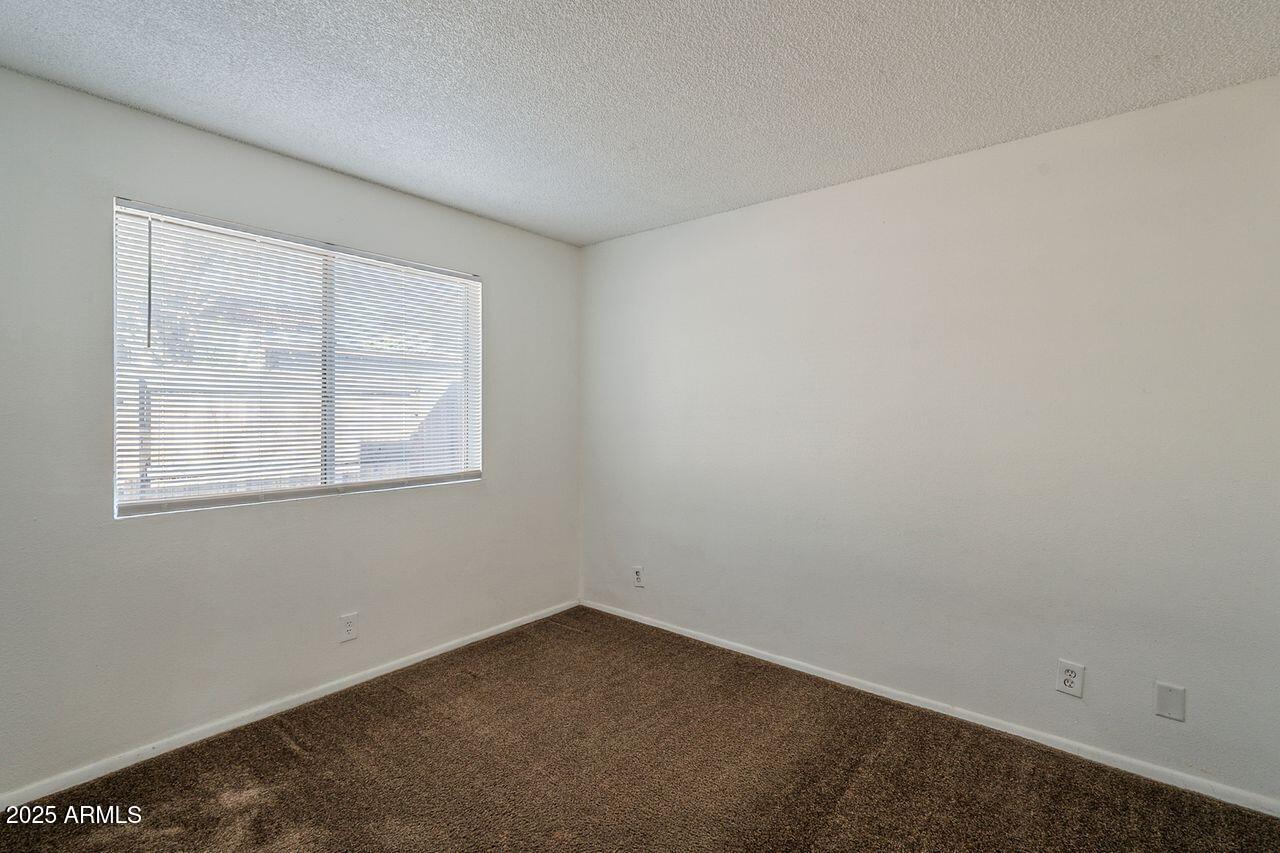 2608 West Ocotillo Road Phoenix, AZ 85017 - Photo 24 of 56 an empty room with a window