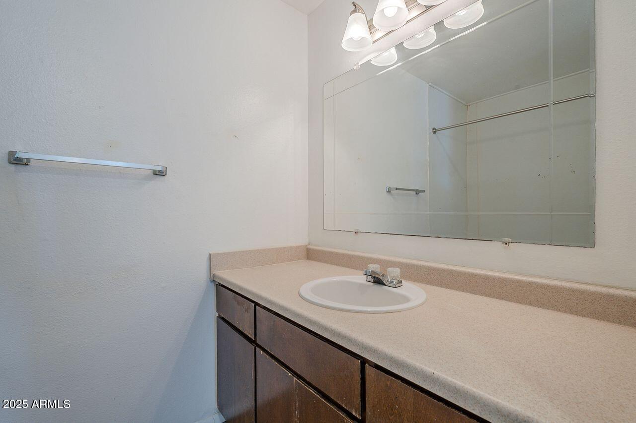 2608 West Ocotillo Road Phoenix, AZ 85017 - Photo 28 of 56 a bathroom with a sink vanity and a mirror