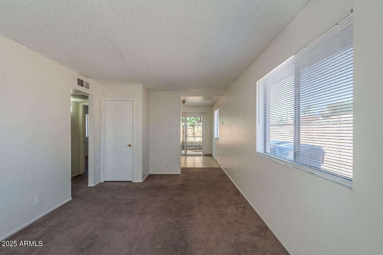 2608 West Ocotillo Road Phoenix, AZ 85017 - Photo 30 of 56 a view of an empty room with wooden floor and a window