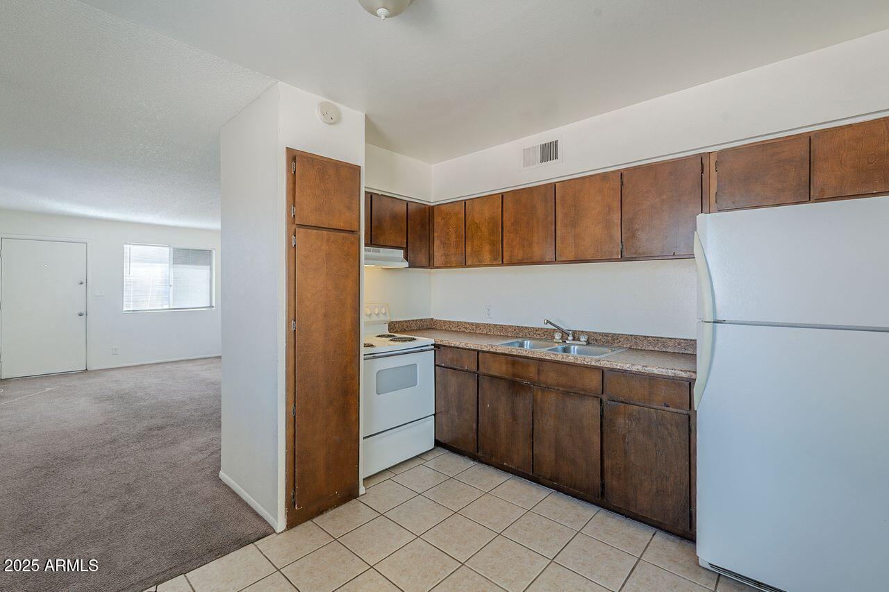 2608 West Ocotillo Road Phoenix, AZ 85017 - Photo 35 of 56 a kitchen with stainless steel appliances granite countertop a refrigerator and a sink