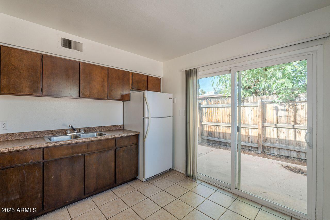 2608 West Ocotillo Road Phoenix, AZ 85017 - Photo 39 of 56 a kitchen with a refrigerator a stove top oven and cabinets