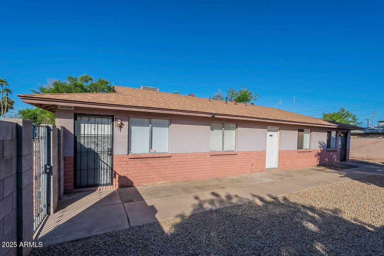 2608 West Ocotillo Road Phoenix, AZ 85017 - Photo 4 of 56 a front view of a house with a yard and garage