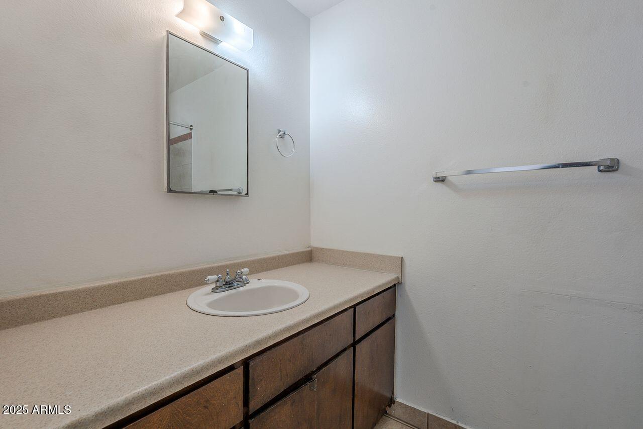 2608 West Ocotillo Road Phoenix, AZ 85017 - Photo 48 of 56 a bathroom with a sink vanity and a mirror