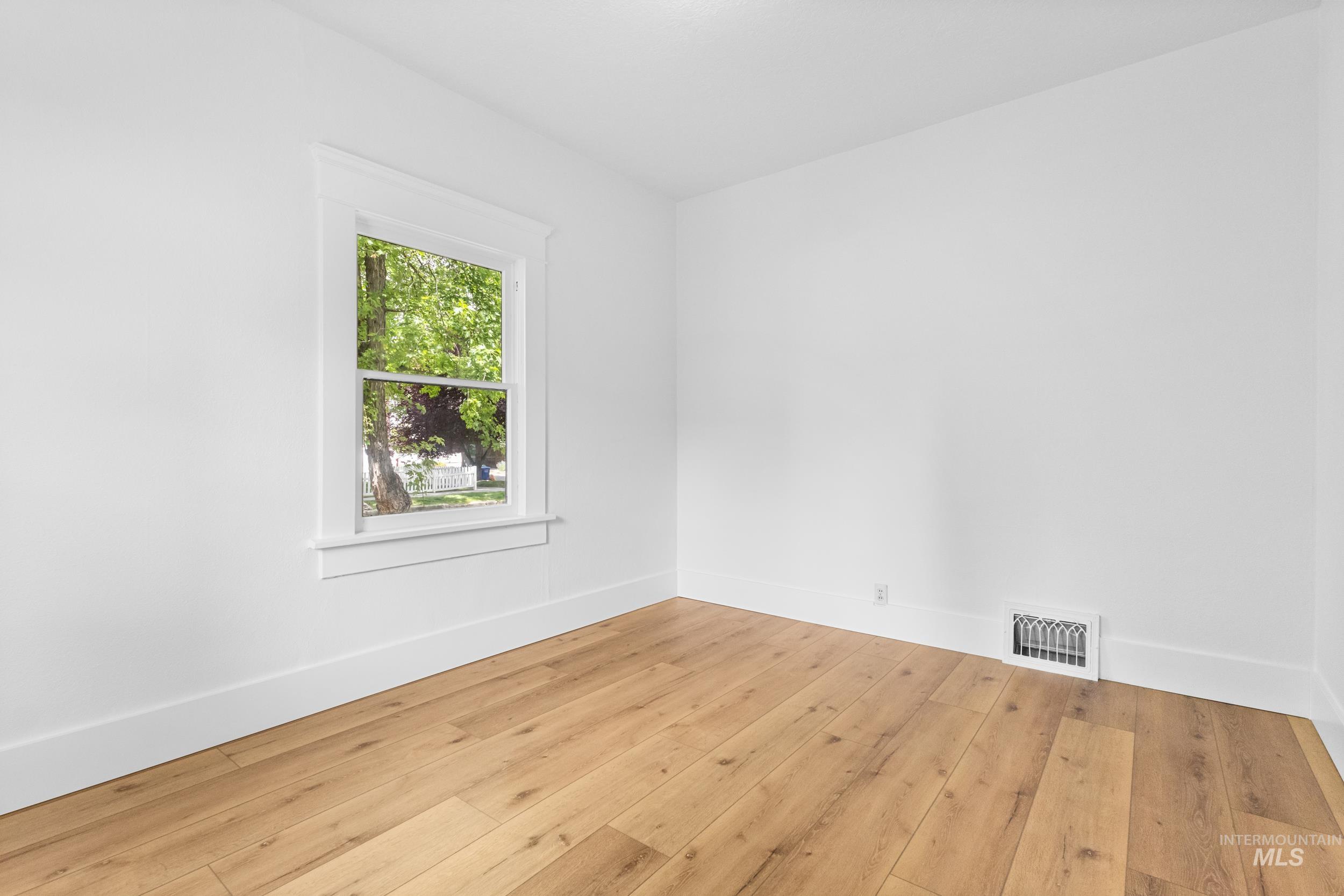 2119 West Brumback Street Boise, ID 83702 - Photo 18 of 30 Room featuring wood-finish flooring, white walls, and bright trim work