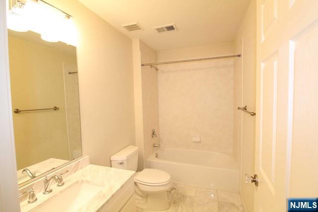 46 Pine Lake Terrace, Unit T046 Westwood, NJ 07675 - Photo 13 of 17 a bathroom with a granite countertop sink toilet and shower