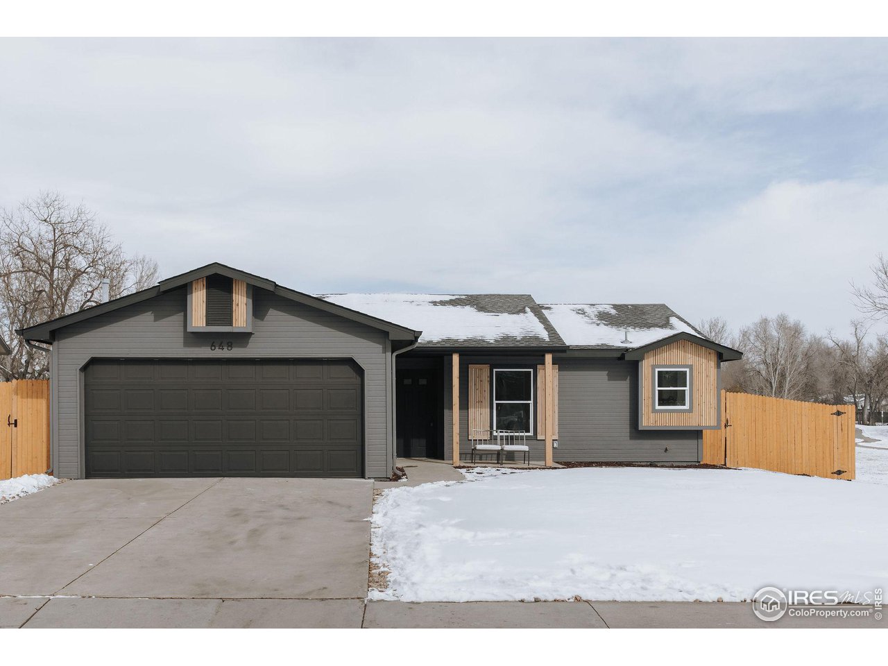 648 Justice Drive Fort Collins, CO 80526 - Photo 1 of 32 a front view of a house with a yard and garage