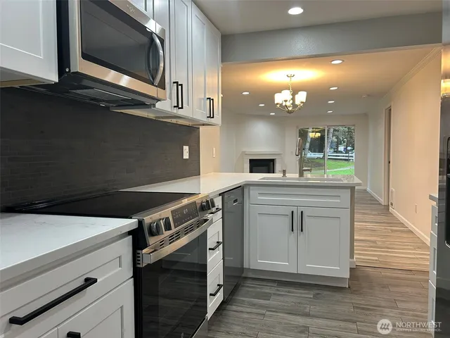 a bathroom with a granite countertop sink toilet and mirror