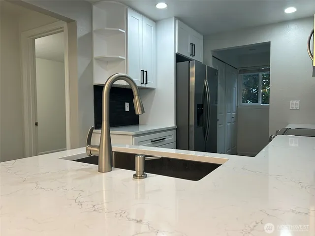 a kitchen with a sink and cabinets