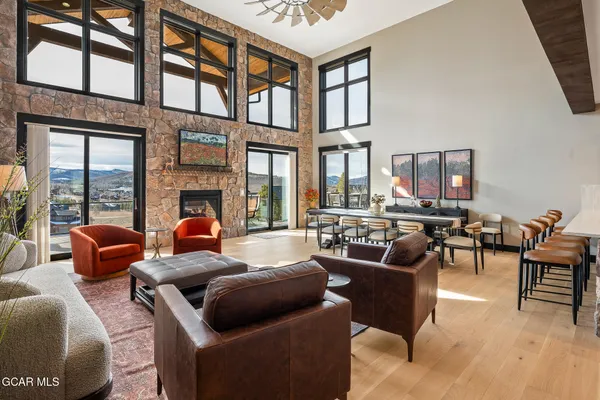 a living room with furniture fireplace and a large window