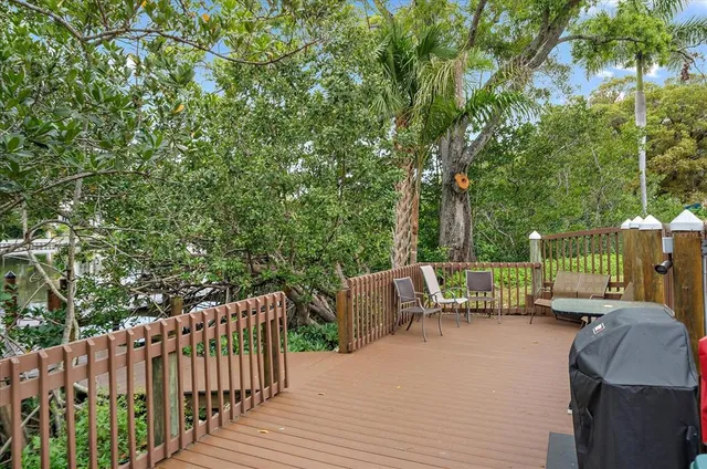 a view of a deck with couches and wooden fence
