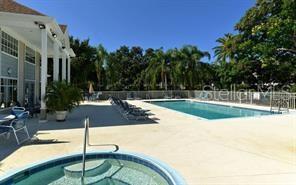850 South Tamiami Trail, Unit 409 Sarasota, FL 34236 - Photo 19 of 22 a swimming pool with outdoor seating and yard