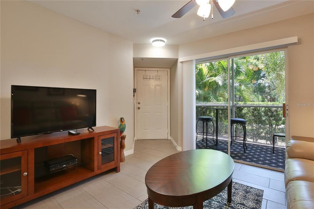 850 South Tamiami Trail, Unit 409 Sarasota, FL 34236 - Photo 5 of 22 a living room with furniture and a flat screen tv