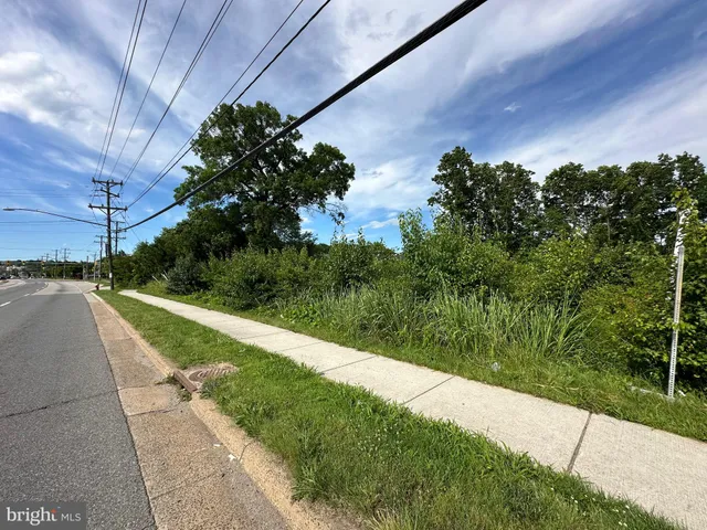 a view of a street with a garden